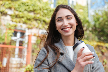 Close-up portrait of a smiling pretty girl outdoors