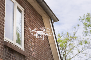 Drone equipped with camera spying through a window 