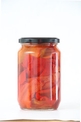 Fototapeta na wymiar Isolated glass jar with conserved roasted red paprika