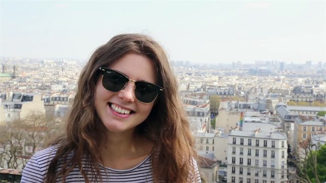 Smiling girl in a summer day in Paris