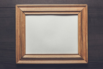 old empty frame on wooden wall