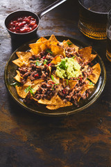 Hot sauce with chips, guacamole and beer