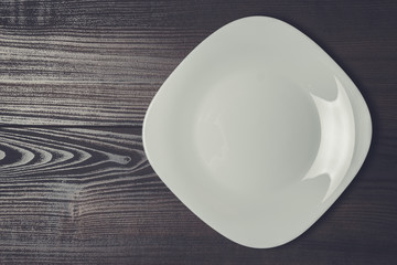 square plate on the wooden brown table