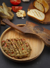 Egplant caviar ( salad ) on a wooden rustic plate over dark table