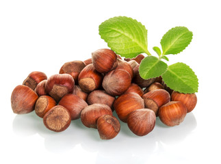 Pile of whole hazelnuts close-up isolated on white