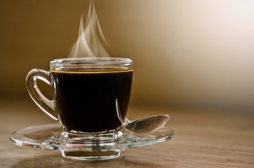 Hot black coffee in glass cup.