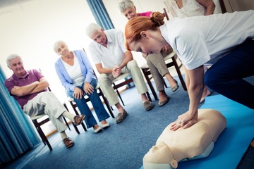 Obraz premium Nurse teaching first aid to a group of seniors