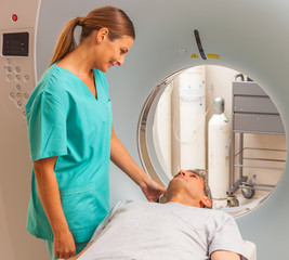 Happy patient undergoing mri scan at hospital