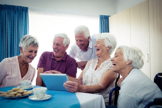 Group of seniors using a tablet computer