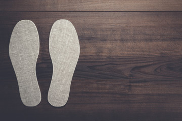 grey insoles for shoes on wooden background