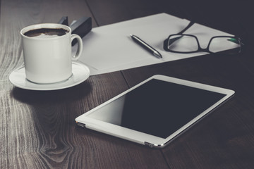 office table of businessman with tablet computer and coffee