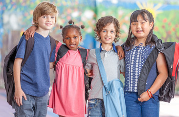 Happy multi ethnic classmates embracing in schoolyard, happiness