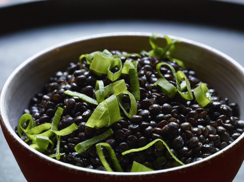 Close-up of garnished black lentils in bowl