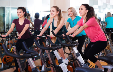 Fototapeta na wymiar Females training on exercise bikes