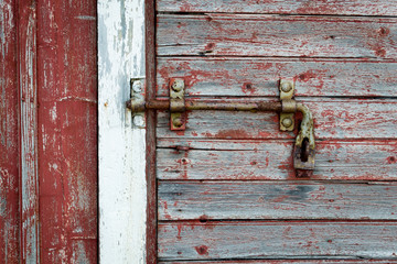 Rusty latch in the old wooden door