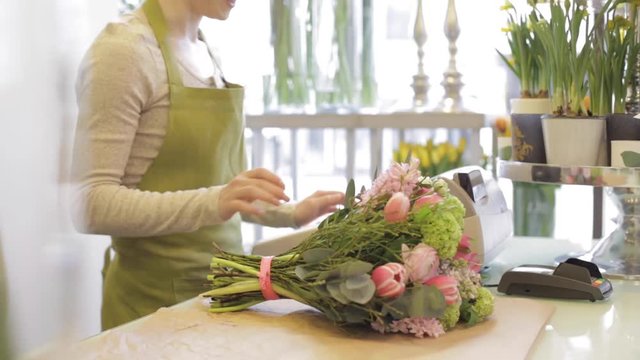 florist woman with flowers and man at flower shop