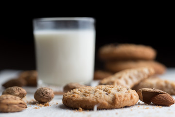 Cookies pile with chocolate chip and almond on light textile background. Delicious morning snacks for breakfast, brunch and lunch. Appetizing, healthy and fast food