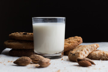 Cookies pile with chocolate chip and almond on light textile background. Delicious morning snacks for breakfast, brunch and lunch. Appetizing, healthy and fast food