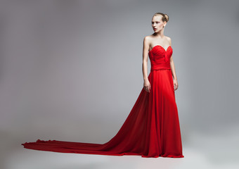 Blonde model posing in red dress with skirt