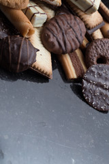 Cookies assorted on black background. Delicious morning snacks for breakfast, brunch and lunch. Appetizing, sweet and fast food.