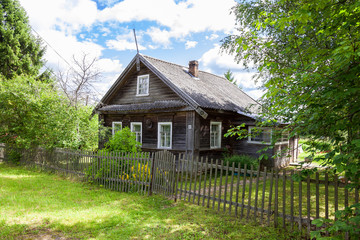 Fototapeta na wymiar Old wooden house in russian village. Novgorod region, Russia