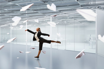 Dancing businesswoman in office