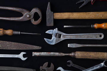 Construction tools set on dark background. Assortment instruments for repairman, carpenter, builder. Copy space for text. Top view. 