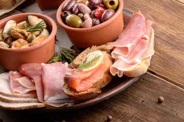 Tapas of salmon, mussels, jamon and olives