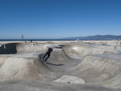 Man skateboarding in skateboard park, Venice Beach, California