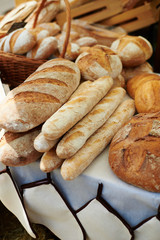 Crusty fresh bread on sale at a market stall.