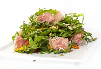 salad of arugula ham cheese on a white background