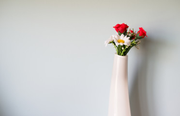 Flowers and white jar glass