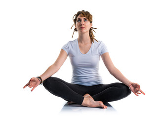Young girl with dreadlocks doing yoga