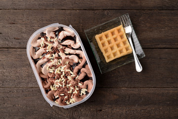 bowl of ice cream with chocolate and hazelnut and wafer waffle