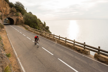 Naklejka premium Early Morning Road Cycling along the Coastal Highway