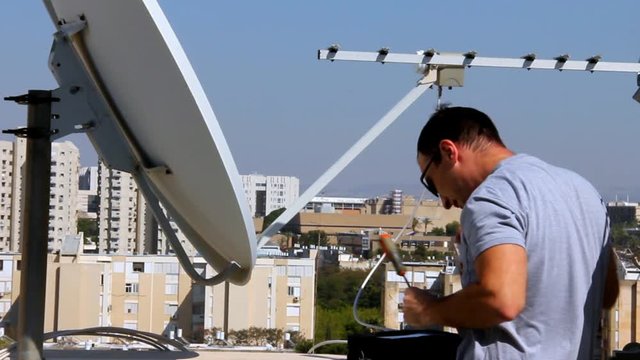 Technician correct installation of the receiving device of satellite dish