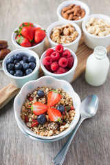 Paleo style breakfast: grain free oat free granola  with almond milk and with mixed nuts, and fresh berries, selective focus