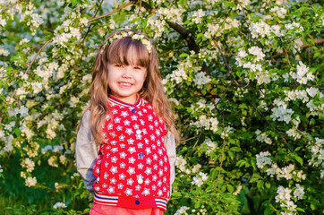 Beautiful girl in blooming garden