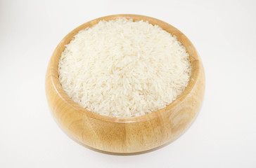 Jasmine rice in a wooden bowl isolated on white background