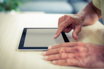 Senior man using digital tablet