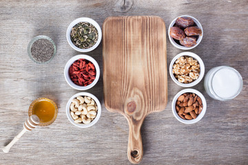 Grain free oat free paleo granola ingredients: mixed nuts, seeds, goji berries, chia, honey and coconut oil, selective focus