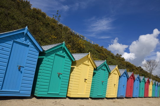 Multicoloured beach huts on the long sweeping beach of Llanbedrog, Llyn Peninsula, Gwynedd, North Wales, Wales