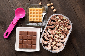 bowl of ice cream with chocolate and hazelnut and wafer waffle