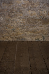 The old stone wall and wooden floor
