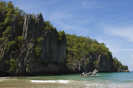 Beach with limestone rock formations at Subterranean River National Park, Sabang Town, Palawan, Philippines
