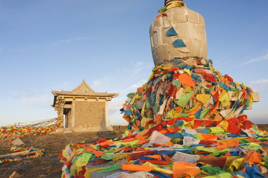 Sunrise on a monastery stupa and prayer flags on Yedou Peak, 3058m, at Wutaishan (Five Terrace Mountain) one of China's sacred Buddhist mountain ranges, Shanxi province, China