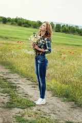 young woman with a bouquet of field daisies