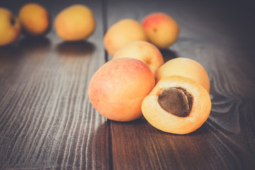 Naklejka na ściany i meble some fresh apricots over brown wooden background