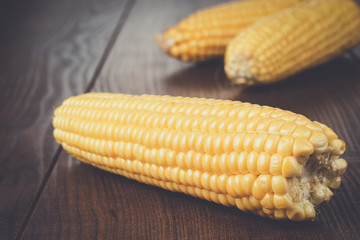 corn cobs on the brown wooden table