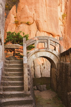 Steps, bridge, and last sunrays on rock face, White Cloud scenic area, Huang Shan (Yellow Mountain), Anhui Province, China
